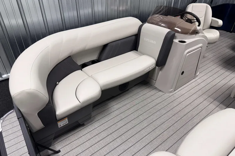 Slide: The Image of 2026 Sylvan Mirage 820 Cruise boat interior with plush seating and modern helm. - 2