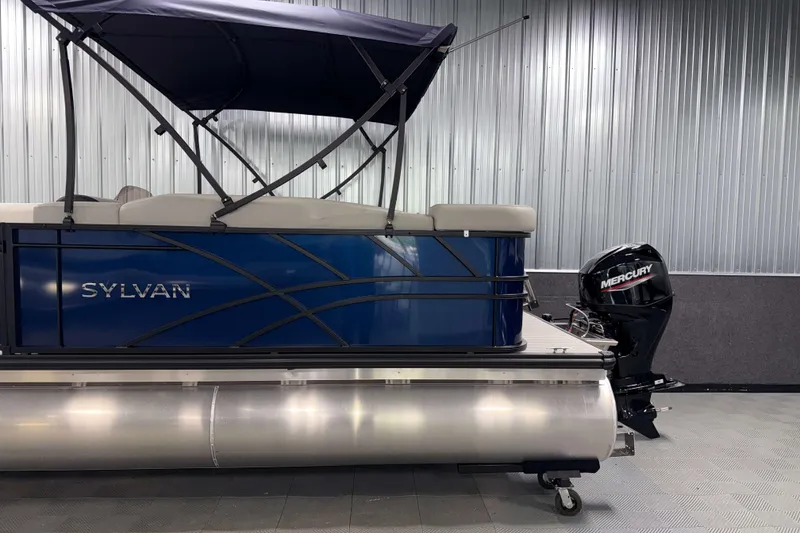Slide: The Image of 2026 Sylvan Mirage 820 Cruise pontoon boat with Mercury outboard motor in showroom. - 20