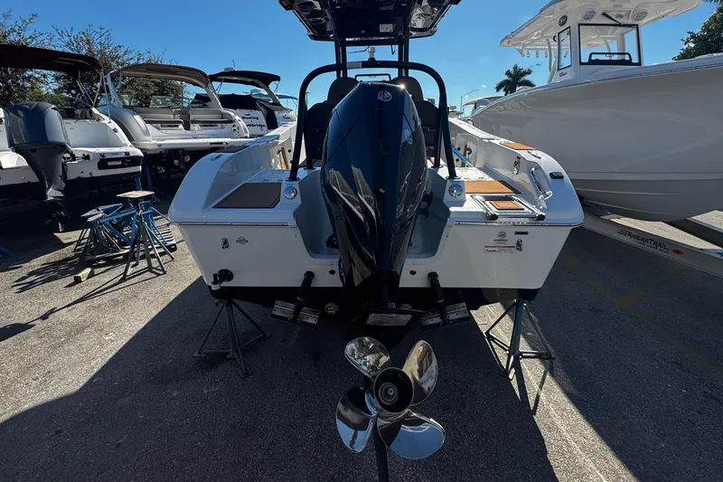 Slide: The Image of 2026 Sea Pro 245FLX Sandbar boat with outboard motor, displayed on stands. - 4