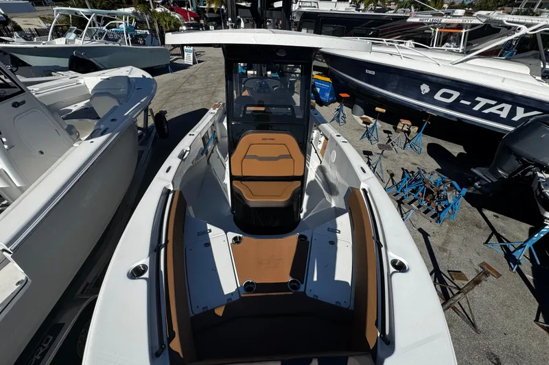 Slide: The Image of 2026 Sea Pro 245FLX Sandbar boat displayed at a marina, showcasing sleek design and seating. - 46