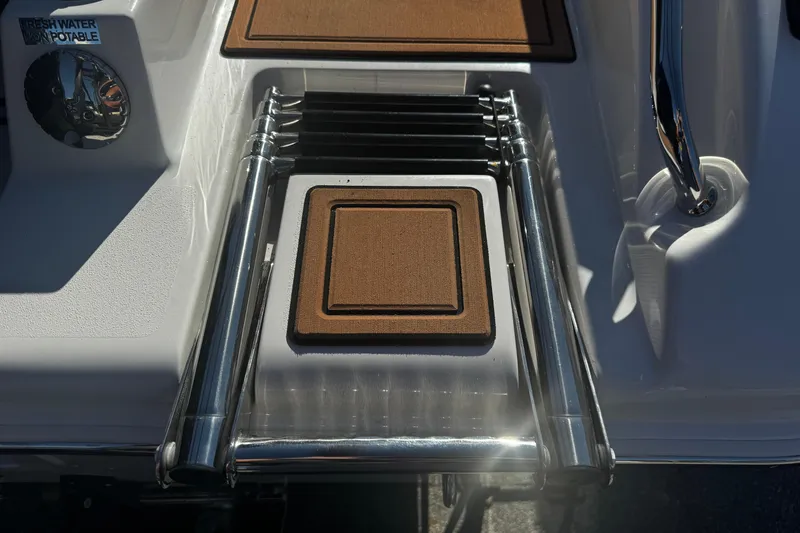 Slide: The Image of 2026 Sea Pro 245FLX Sandbar boat ladder with teak steps and fresh water access. - 8