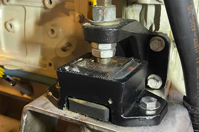 Slide: The Image of Engine mount detail on a 2002 President Trawler, showcasing bolts and metal components. - 104