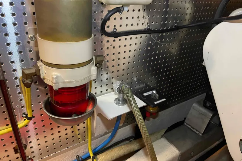 Slide: The Image of Engine room of a 2002 President Trawler with fuel filter and hoses. - 107