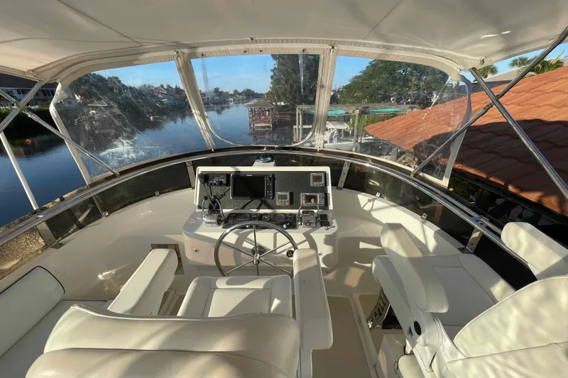 Slide: The Image of Helm of 2002 President Trawler with modern controls, overlooking serene waterway. - 15