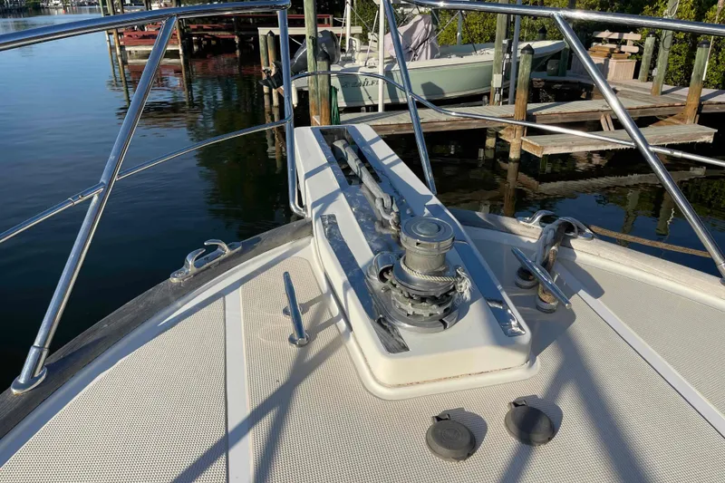 Slide: The Image of Bow of a 2002 President Trawler boat with anchor winch, docked at marina. - 18