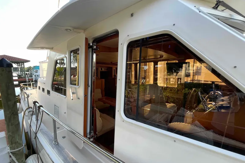 Slide: The Image of 2002 President Trawler yacht exterior with open cabin door and visible interior. - 3