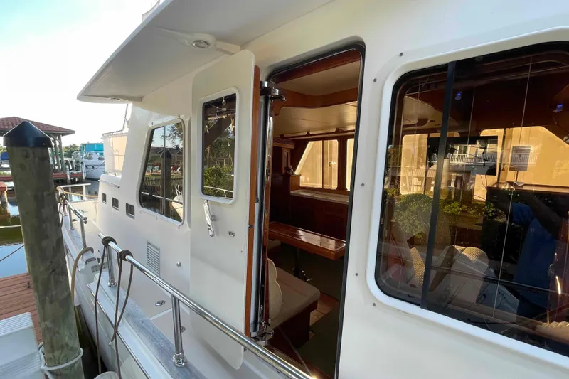 Slide: The Image of 2002 President Trawler yacht docked, showcasing exterior and interior views. - 30
