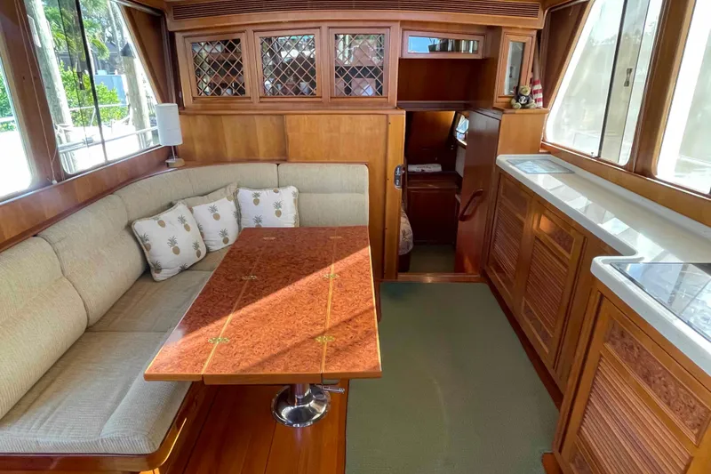 Slide: The Image of Cozy interior of 2002 President Trawler with wood accents and cushioned seating. - 32
