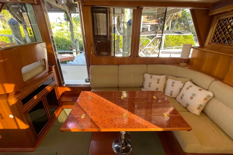 Slide: The Image of Interior of 2002 President Trawler with elegant wood table and cushioned seating. - 33