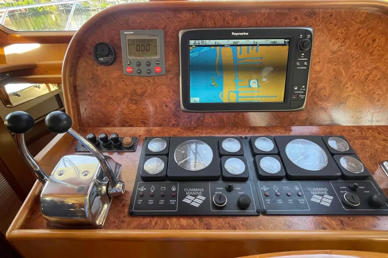 Slide: The Image of Control panel of a 2002 President Trawler with navigation and engine gauges. - 39