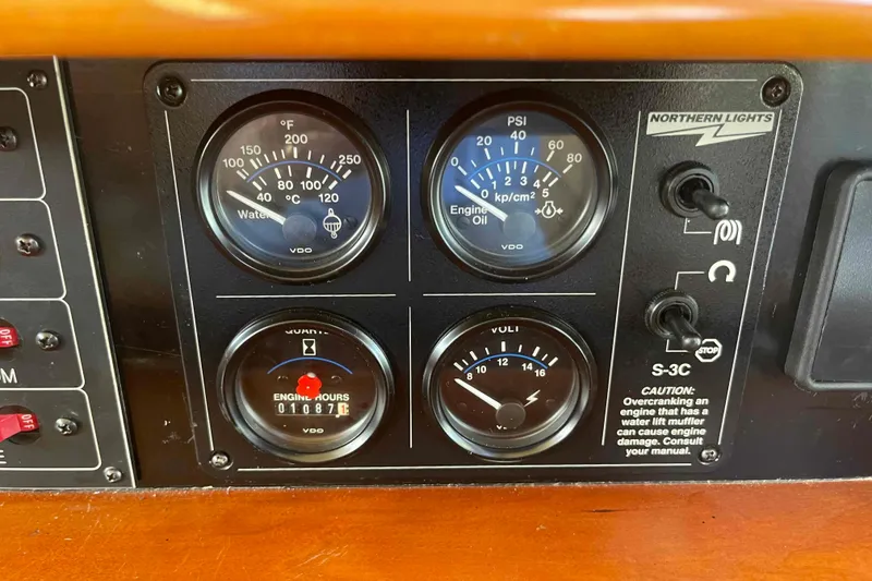 Slide: The Image of 2002 President Trawler engine panel with gauges for water temperature, oil pressure, and engine hours. - 45