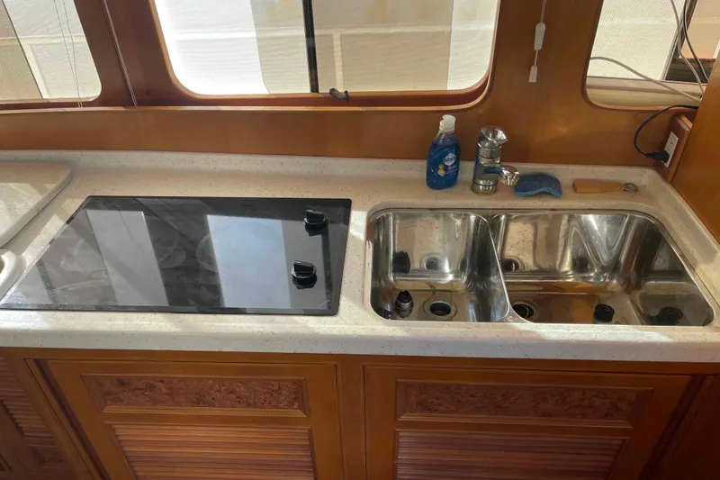 Slide: The Image of Kitchen area of a 2002 President Trawler with stove and double sink. - 49