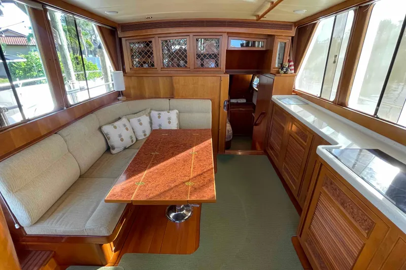Slide: The Image of Luxurious 2002 President Trawler interior with elegant wood finishes and cozy seating area. - 5