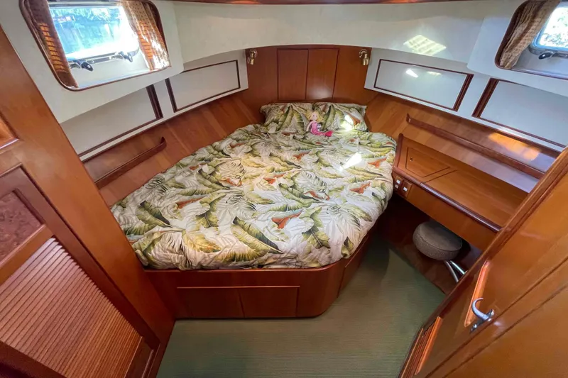 Slide: The Image of Cozy bedroom in 2002 President Trawler with tropical bedding and wooden interior. - 57