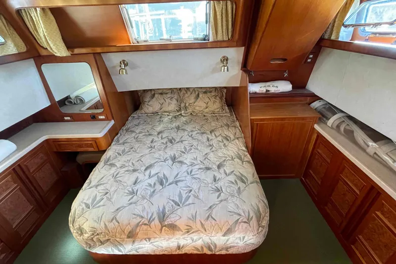 Slide: The Image of Cozy bedroom in 2002 President Trawler with wood cabinetry and floral bedding. - 62