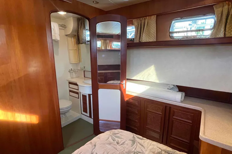 Slide: The Image of Luxurious 2002 President Trawler cabin interior with wood finish and ensuite bathroom. - 66