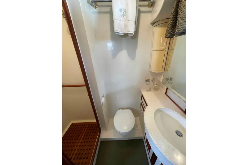 Slide: The Image of Compact bathroom in 2002 President Trawler with sink, toilet, and shower area. - 69
