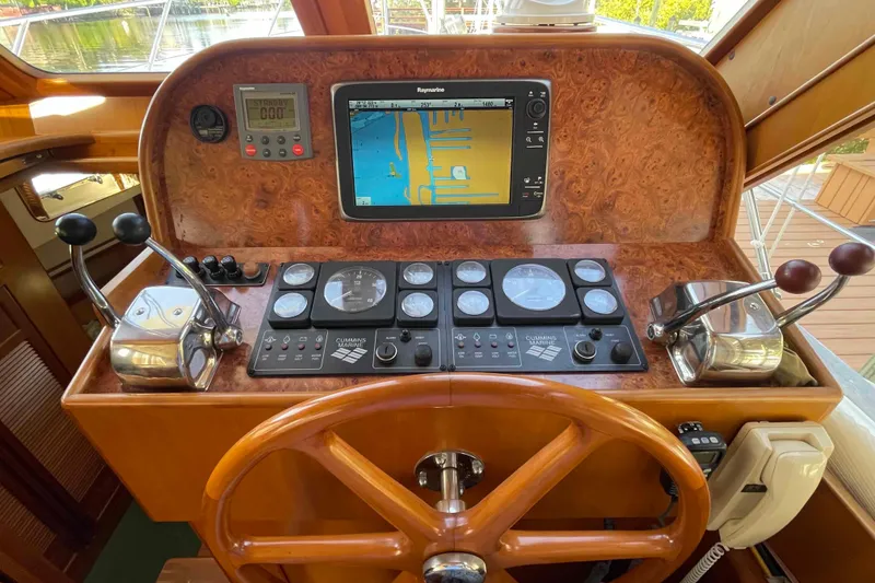 Slide: The Image of Control panel of a 2002 President Trawler with navigation and engine controls. - 7