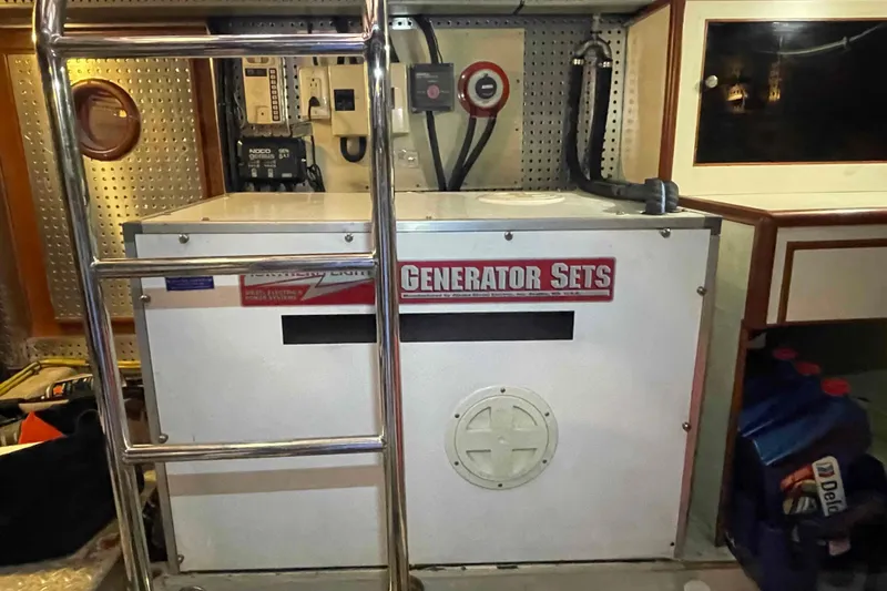 Slide: The Image of Engine room of a 2002 President Trawler featuring a generator set and control panel. - 84