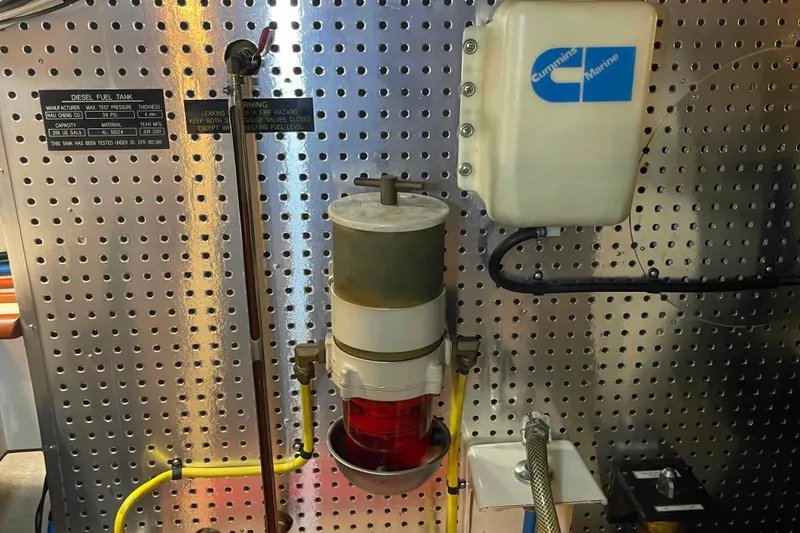 Slide: The Image of Engine room of 2002 President Trawler with Cummins Marine components and fuel system. - 89