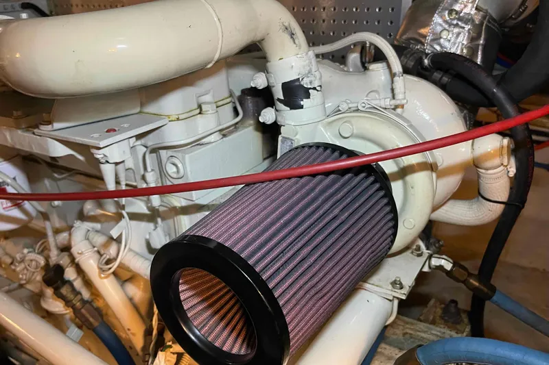 Slide: The Image of Engine compartment of a 2002 President Trawler with visible air filter and piping. - 92