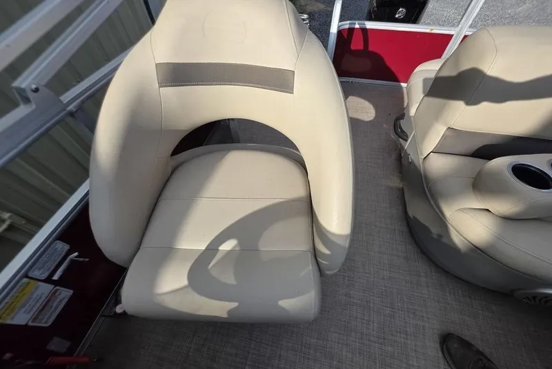 Slide: The Image of 2023 Sun Tracker Party Barge 18 DLX beige boat seats with cup holder. - 11