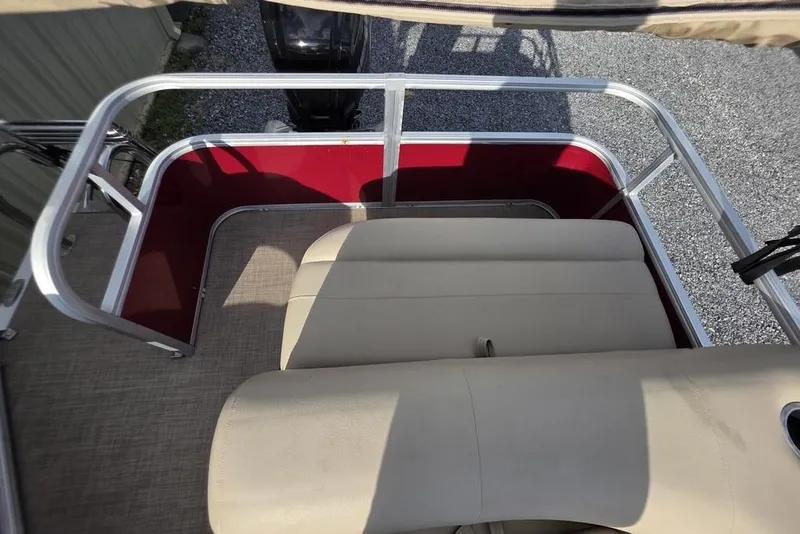 Slide: The Image of 2023 Sun Tracker Party Barge 18 DLX interior with beige seating and red accents. - 12