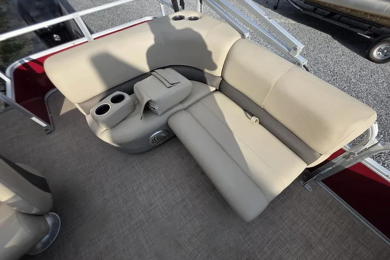 Slide: The Image of 2023 Sun Tracker Party Barge 18 DLX interior with beige seating and cup holders. - 13
