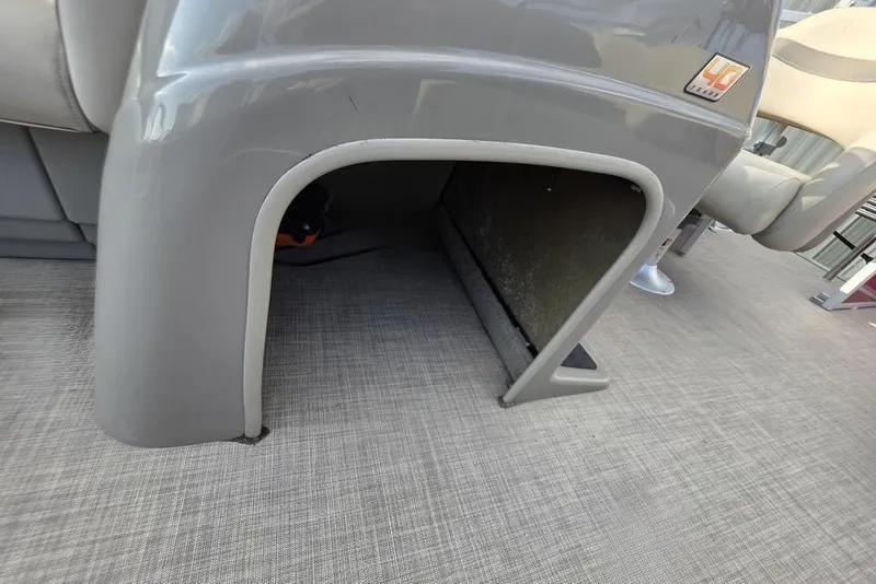 Slide: The Image of 2023 Sun Tracker Party Barge 18 DLX pontoon boat interior detail, gray seating and flooring. - 18