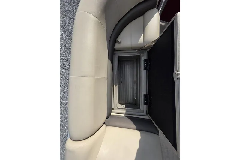 Slide: The Image of 2023 Sun Tracker Party Barge 18 DLX storage compartment with open seat cushion. - 4