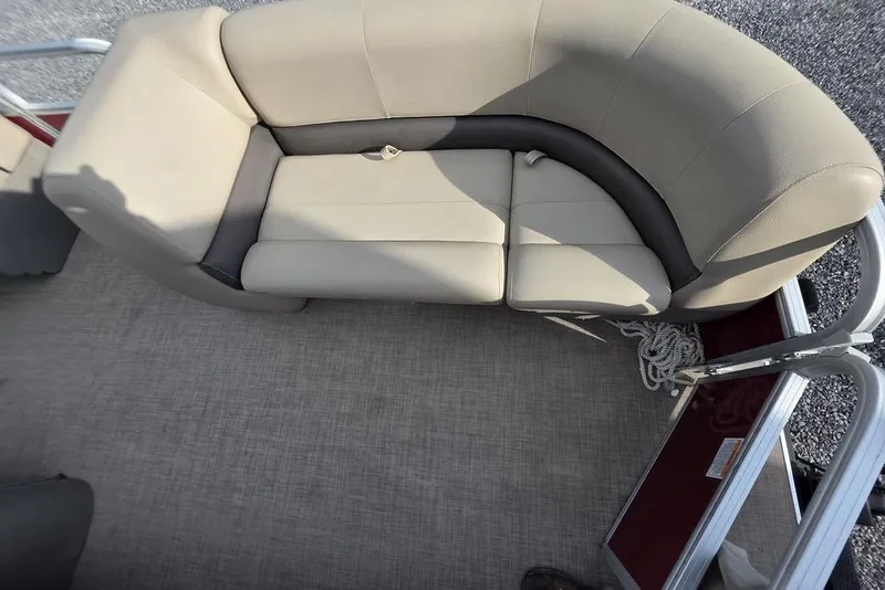 Slide: The Image of 2023 Sun Tracker Party Barge 18 DLX interior with beige seating and carpeted floor. - 8