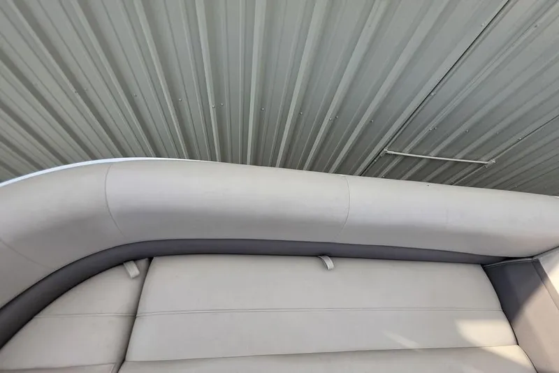 Slide: The Image of 2023 Sun Tracker Party Barge 18 DLX interior seating, featuring light gray upholstery. - 9