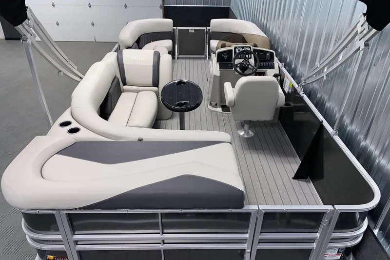 Slide: The Image of 2026 Sylvan Mirage 820 Cruise pontoon boat interior with plush seating and modern helm. - 11