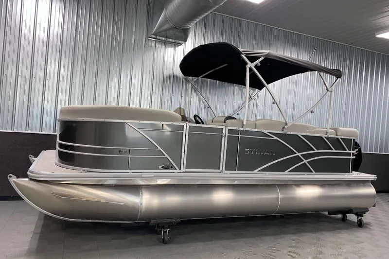 Slide: The Image of 2026 Sylvan Mirage 820 Cruise pontoon boat in a showroom with metallic finish. - 12