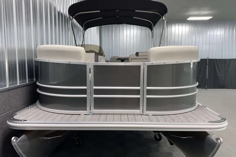 Slide: The Image of 2026 Sylvan Mirage 820 Cruise pontoon boat in a metallic indoor showroom. - 13