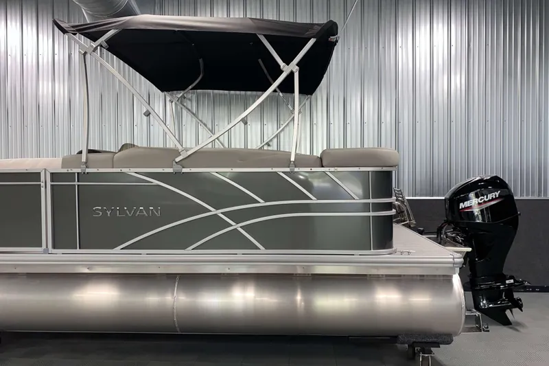 Slide: The Image of 2026 Sylvan Mirage 820 Cruise pontoon boat with Mercury outboard motor in a showroom. - 16