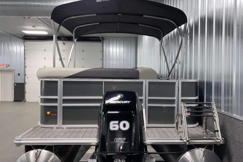 Slide: The Image of 2026 Sylvan Mirage 820 Cruise pontoon boat with Mercury 60 GT engine in a garage. - 18