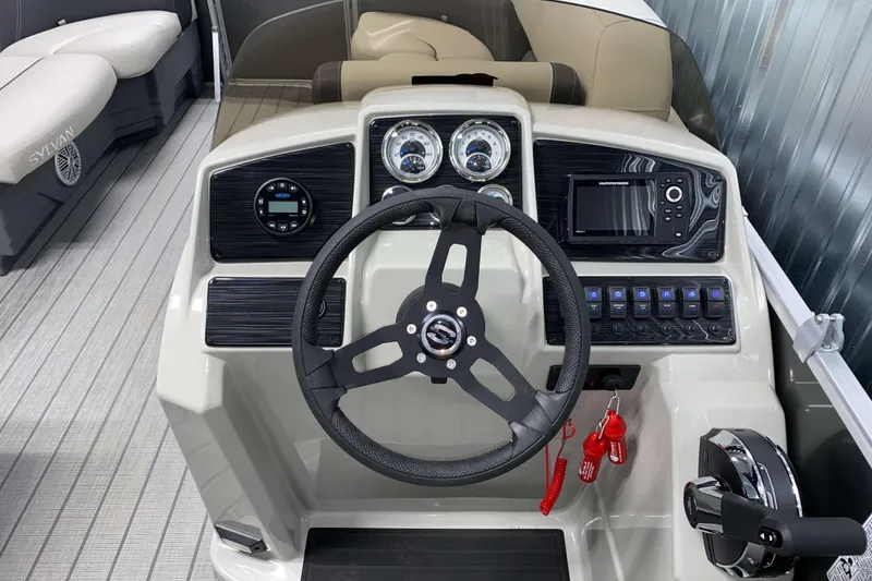 Slide: The Image of 2026 Sylvan Mirage 820 Cruise dashboard with steering wheel and control panel. - 8