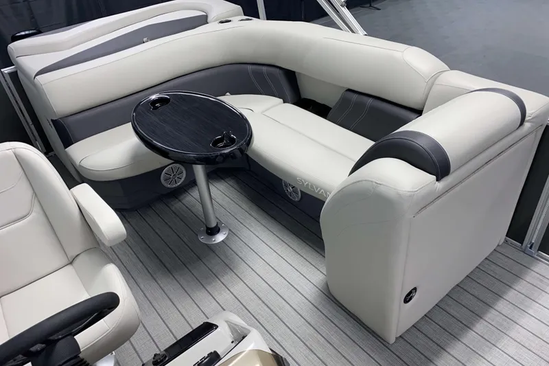 Slide: The Image of 2026 Sylvan Mirage 820 Cruise interior with plush seating and sleek table design. - 9