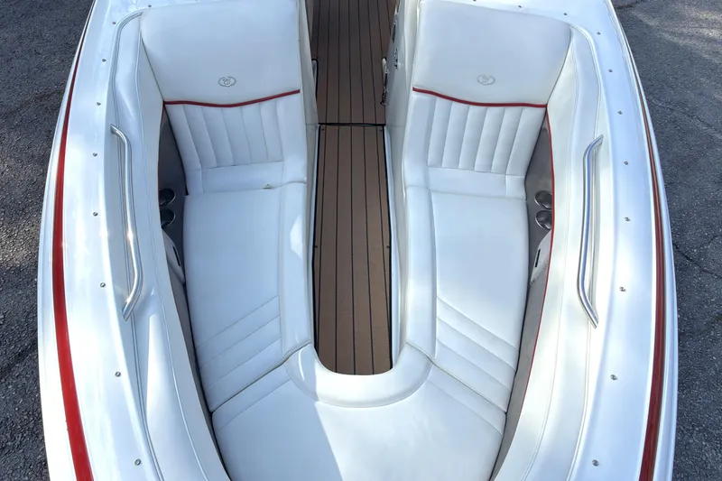 Slide: The Image of 2004 Cobalt 262 boat interior with white leather seats and red accents. - 14