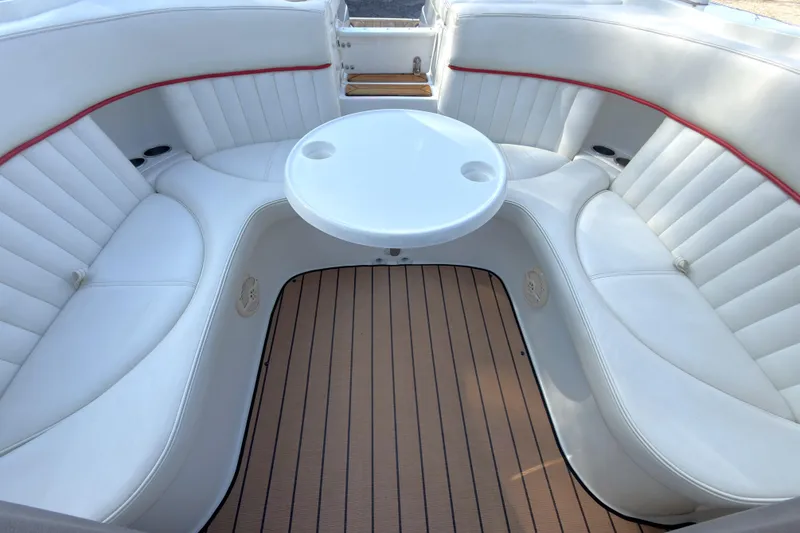 Slide: The Image of Luxurious seating area on a 2004 Cobalt 262 boat with white upholstery and table. - 17