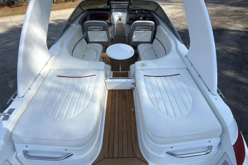 Slide: The Image of Interior of a 2004 Cobalt 262 boat with white seating and wooden flooring. - 4