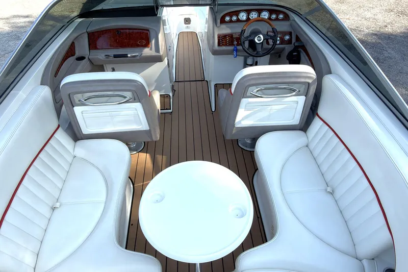 Slide: The Image of Interior of a 2004 Cobalt 262 boat with white seating and wood flooring. - 5