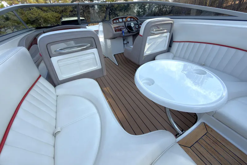 Slide: The Image of Luxurious interior of a 2004 Cobalt 262 boat with white seating and wooden flooring. - 6