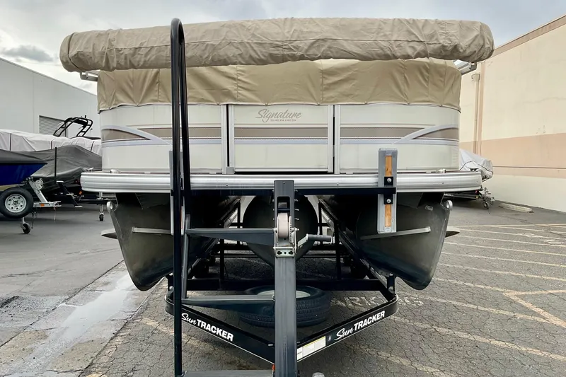 Slide: The Image of 2015 Sun Tracker Party Barge 22 XP3 pontoon boat on trailer, beige and white design. - 5