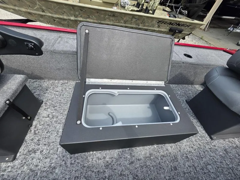 Slide: The Image of 2025 Tracker Panfish™ 17 boat interior with open storage compartment. - 4