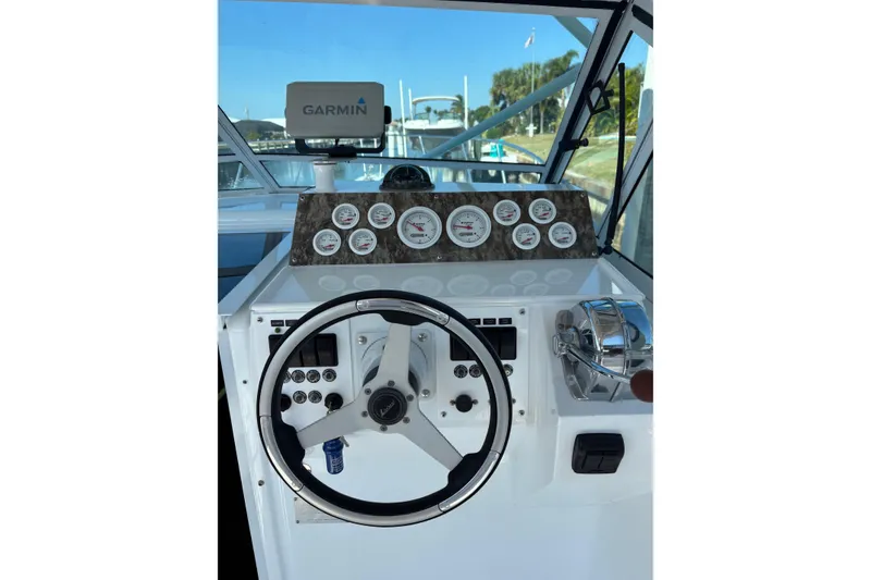 Slide: The Image of 1987 Chris Craft Amerosport helm with Garmin navigation and classic gauges. - 11