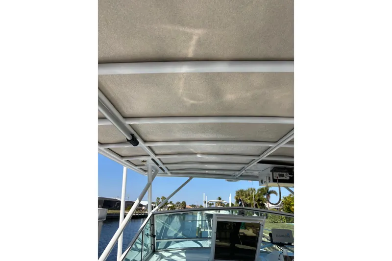 Slide: The Image of 1987 Chris Craft Amerosport boat canopy and windshield with clear sky background. - 12