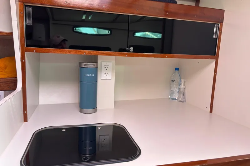 Slide: The Image of 1987 Chris Craft Amerosport cabin kitchen with Keurig, water bottle, and soap dispenser. - 13