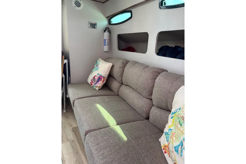 Slide: The Image of Interior of 1987 Chris Craft Amerosport with cozy sofa and decorative pillows. - 14